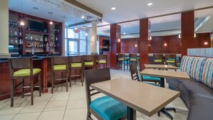 A restaurant with wooden furniture, a bar area, and a seating section. - Holiday Inn Manassas - Battlefield by IHG (Manassas)