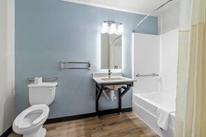 A bathroom with a toilet, sink, and bathtub. - WoodSpring Suites Memphis East I-40 (Memphis)