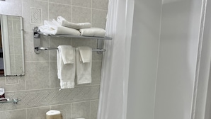 A bathroom with a toilet, sink, and shower. - Chief Motel (Keokuk)