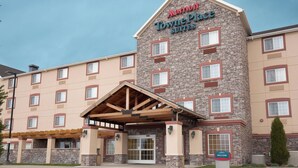 A Marriott TownePlace Suites hotel with a stone facade, multiple windows, and a covered entrance. - TownePlace Suites by Marriott Pocatello (Pocatello)
