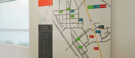A wall map with a TownMap sign, various street names, and icons indicating amenities like eateries and live music venues.