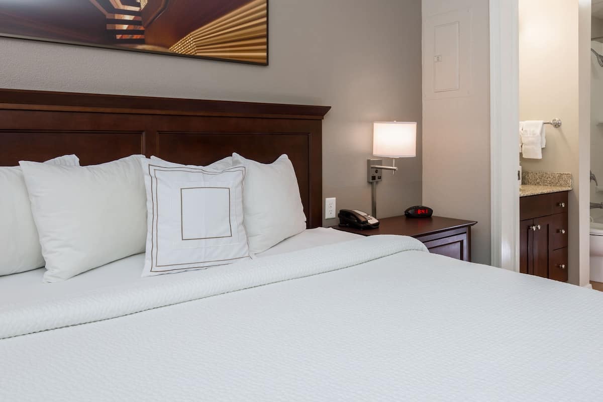 Premium bedding, desk, laptop workspace, iron/ironing board