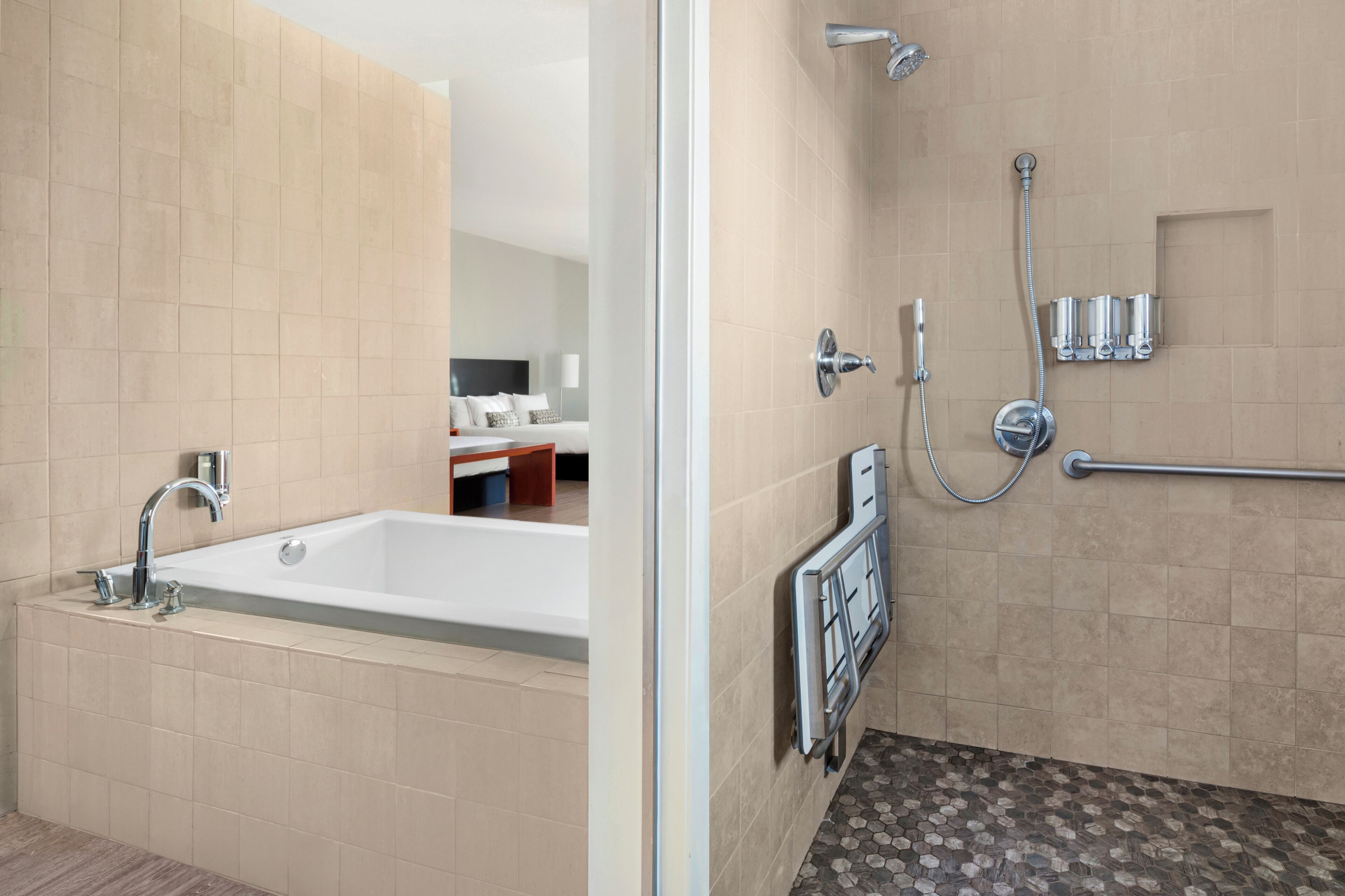 A modern bathroom with a bathtub, shower, and toilet.