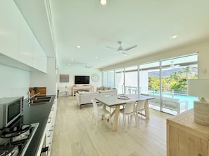 3 Bedroom Sunset Pool View | Living area | 50-inch Smart TV with digital channels, Netflix, books - Pool Port Douglas (Port Douglas)