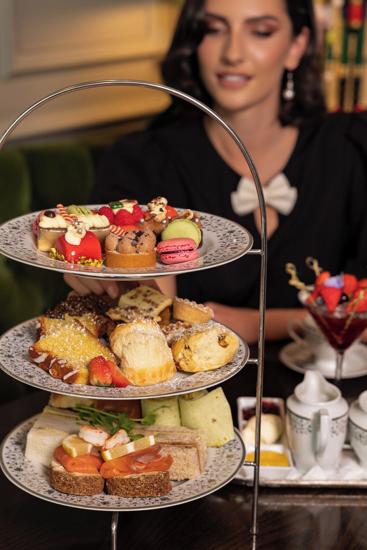A tiered dessert stand with various pastries and macarons.