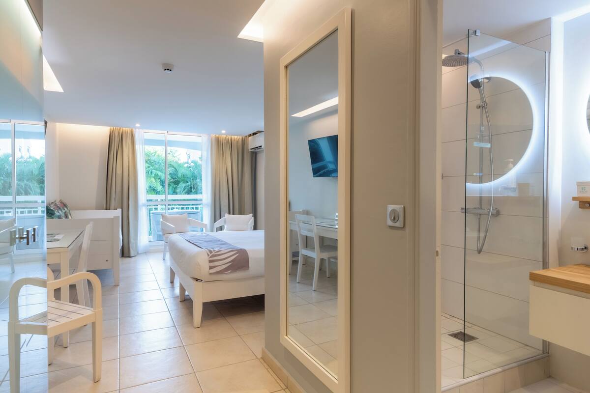 comfort triple room, garden view | premium bedding, in-room safe, laptop workspace, blackout curtains