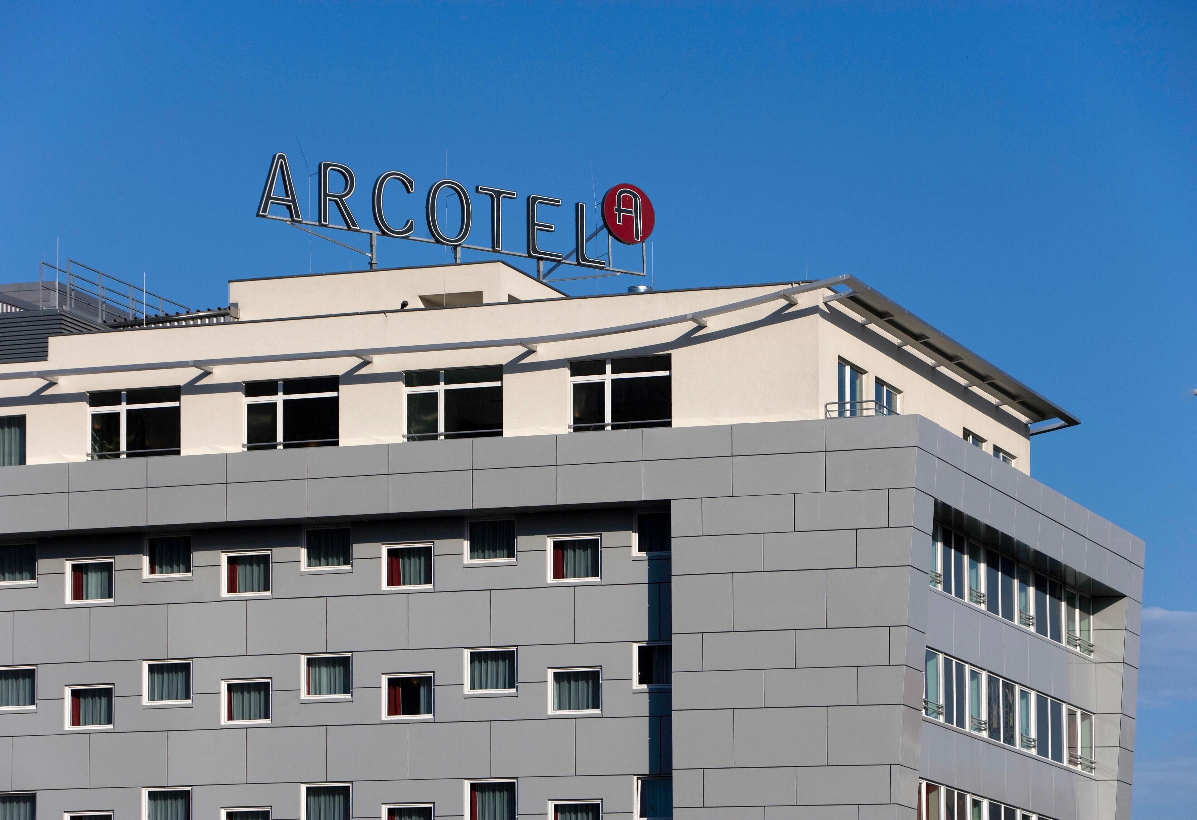 A modern building with the sign "ARCOTEL" on the roof.