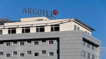 A modern building with the sign "ARCOTEL" on the roof.