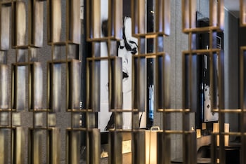 A modern gym with treadmills, weight machines, and a coffee station. at The Hazelton Hotel Toronto
