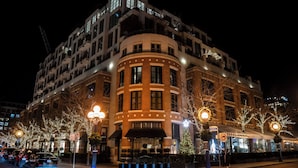 A multi-story hotel with a curved facade, large windows, and a central entrance with a black awning. - The Hazelton Hotel Toronto (Toronto)