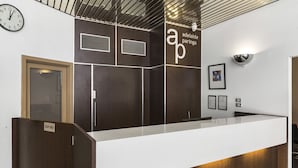 A reception desk with a sign reading "adelaide paringa."