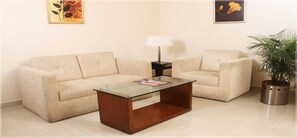 Relax in this stylish living room with a sofa, coffee table, and side table, perfect for unwinding in comfort.