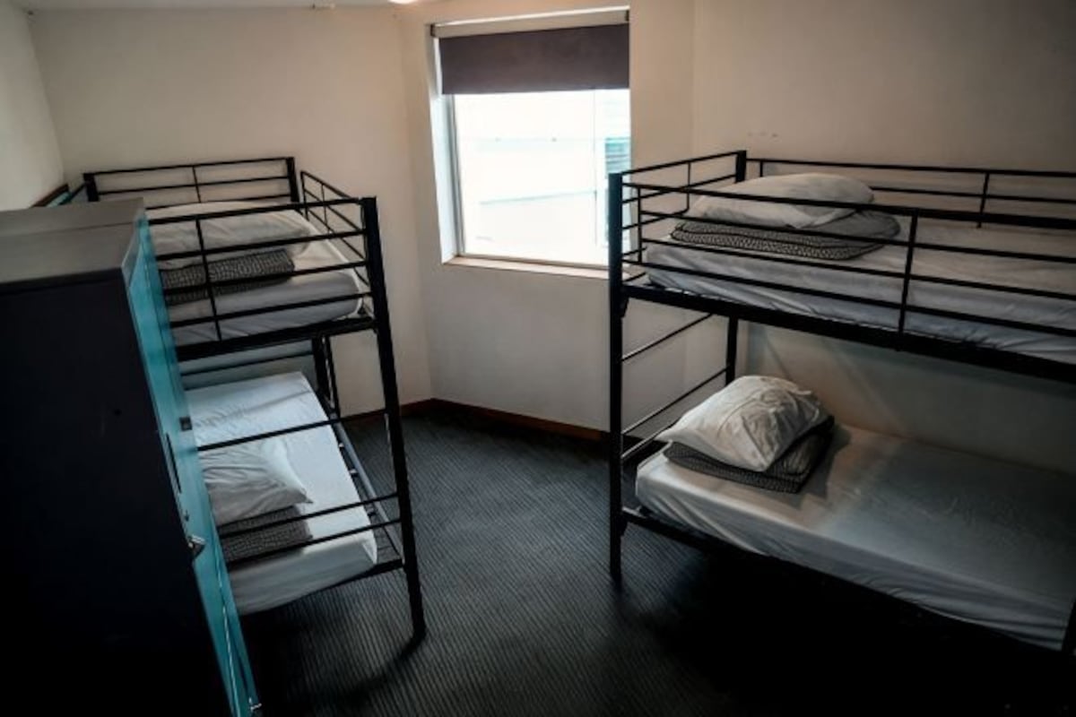 Bunk beds in a room with a window.