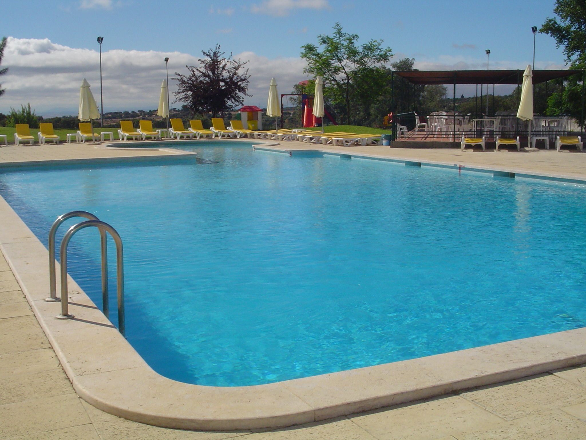seasonal outdoor pool, open 10 am to 7 pm, pool umbrellas, pool loungers