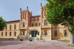 A historic building with a central entrance, multiple windows, and a symmetrical facade. -  1881 Hotel Balneario Vichy Catalan (Caldes de Malavella)