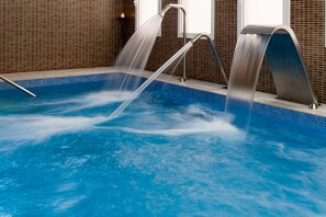 A swimming pool with a water feature, tiled walls, and a metal railing. -  1881 Hotel Balneario Vichy Catalan (Caldes de Malavella)