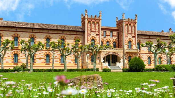 A historic building with a symmetrical facade, arched windows, and a central entrance. -  1881 Hotel Balneario Vichy Catalan (Caldes de Malavella)