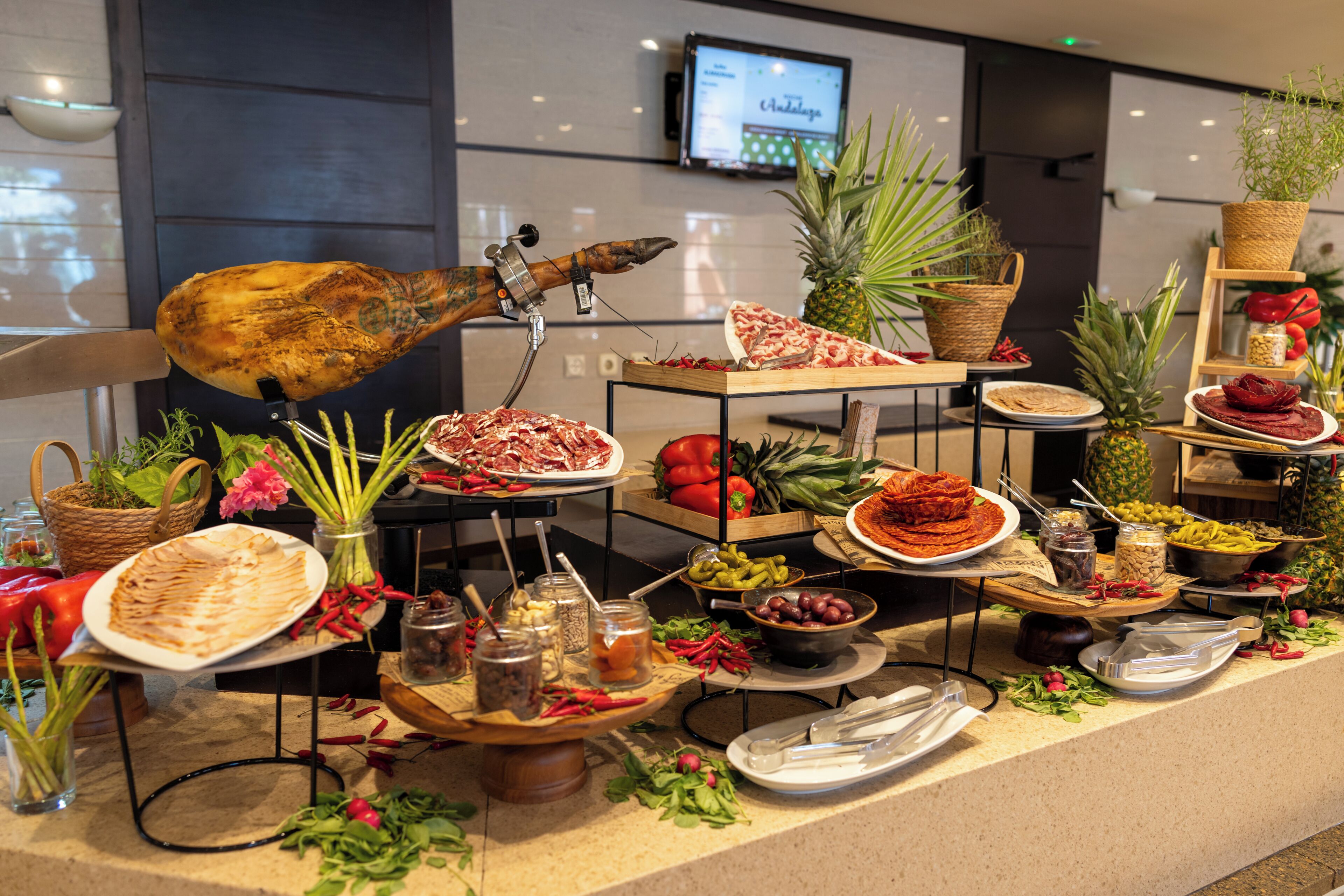 A buffet setup with various food items and a decorative bird sculpture.