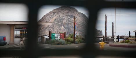 A mountain with a restaurant sign in the foreground.