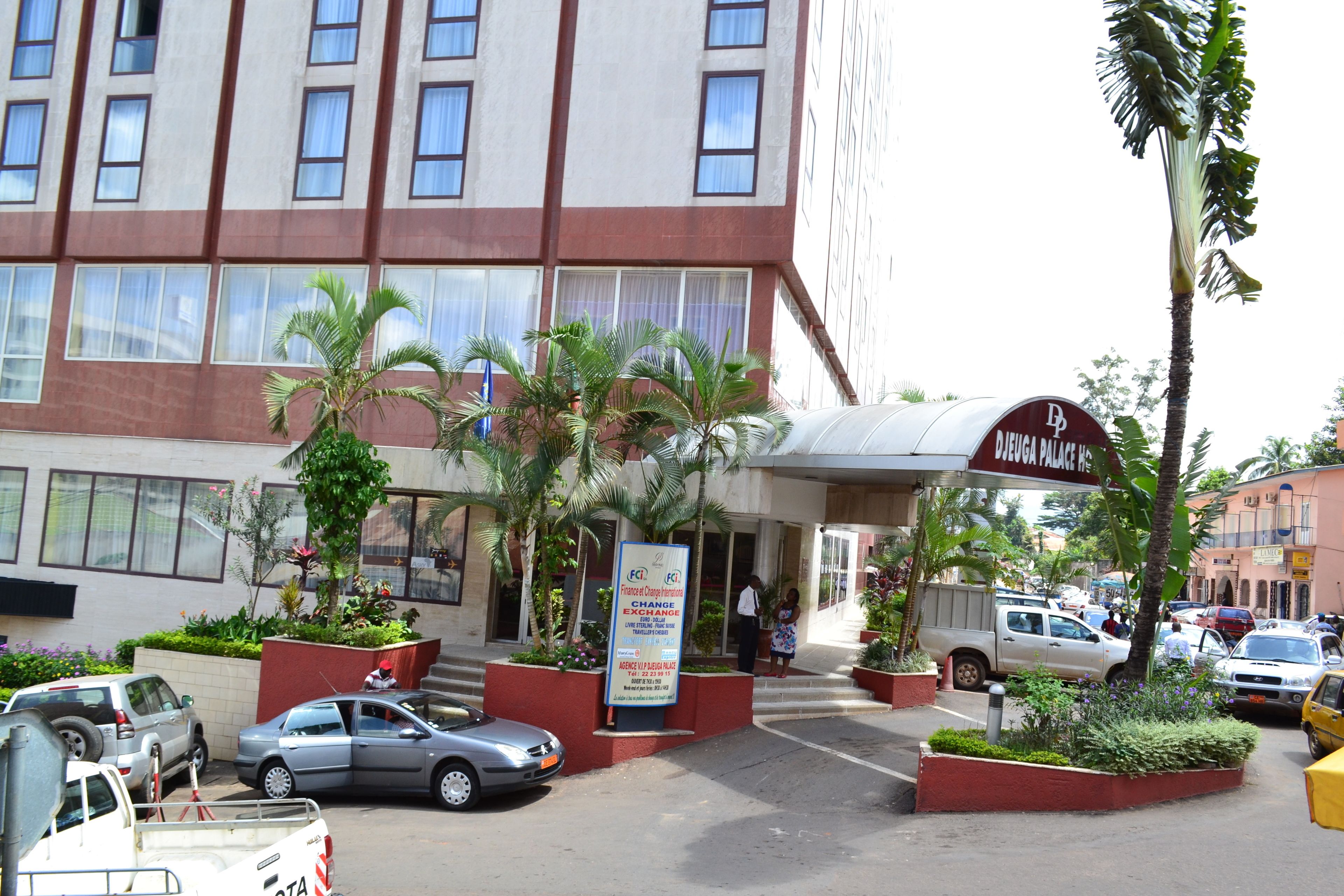 A hotel entrance with a sign for 'DEFIA PALACE'.