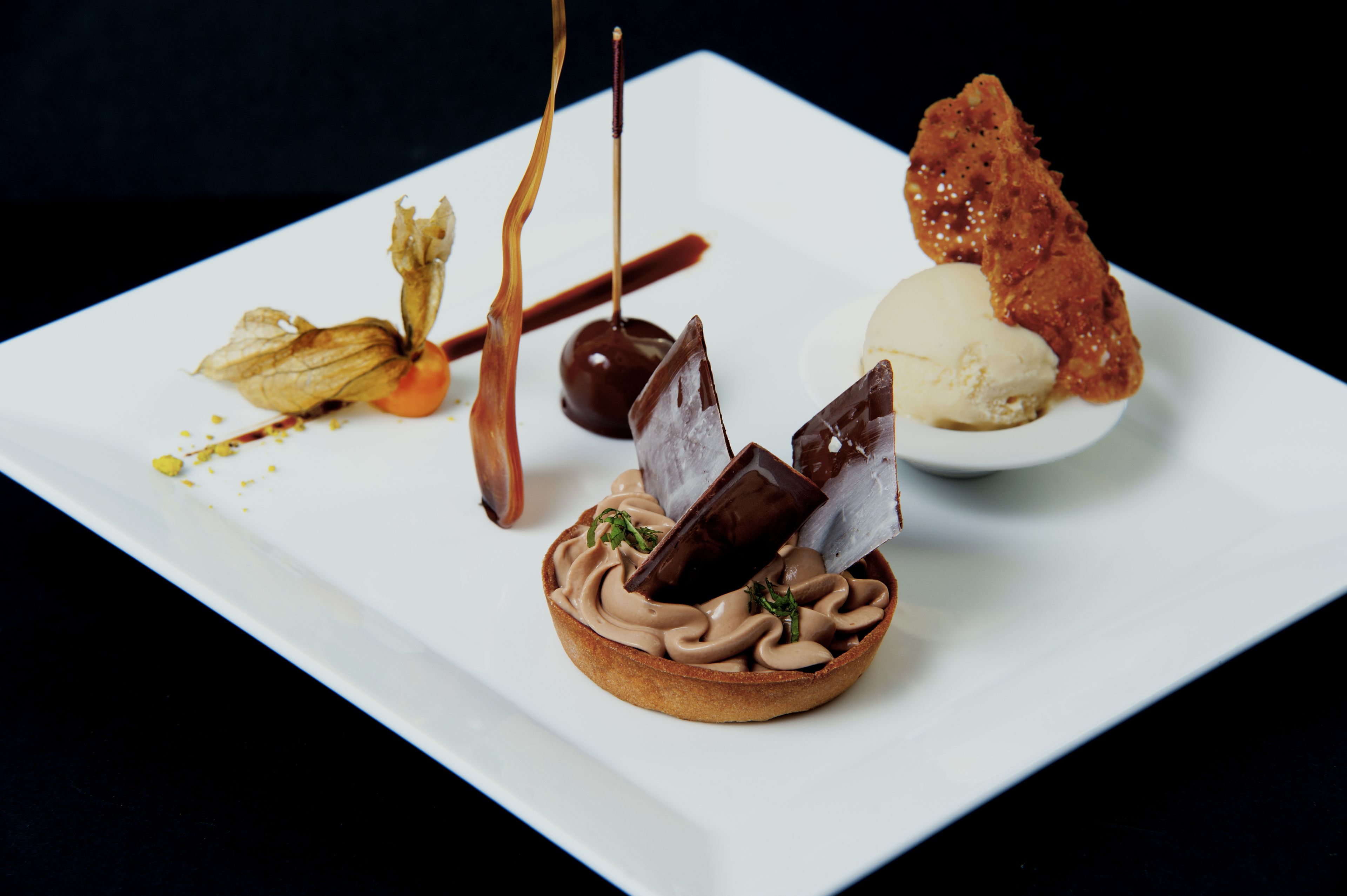 A dessert plate with various chocolate and caramel treats.