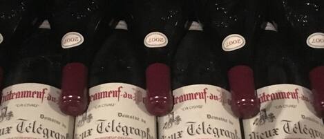 Multiple bottles of red wine with labels indicating 'Domaine du Télégraphe' and vintage years 2007 and 2008.
