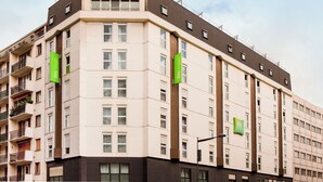 A multi-story hotel with a beige facade, balconies, and green signage indicating "ibis hotels". - ibis Styles Paris Mairie de Montreuil (Montreuil)