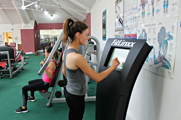 A gym with exercise machines and a FILLINX device.