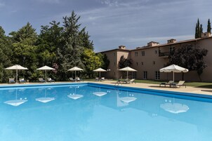 Seasonal outdoor pool, open 9:00 AM to 8:00 PM, pool umbrellas