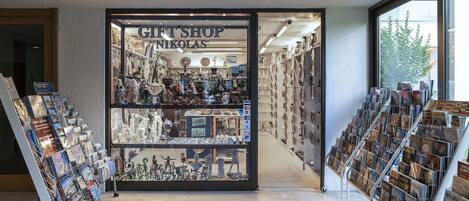 A gift shop with a variety of items on display, including books, ceramics, and other souvenirs.