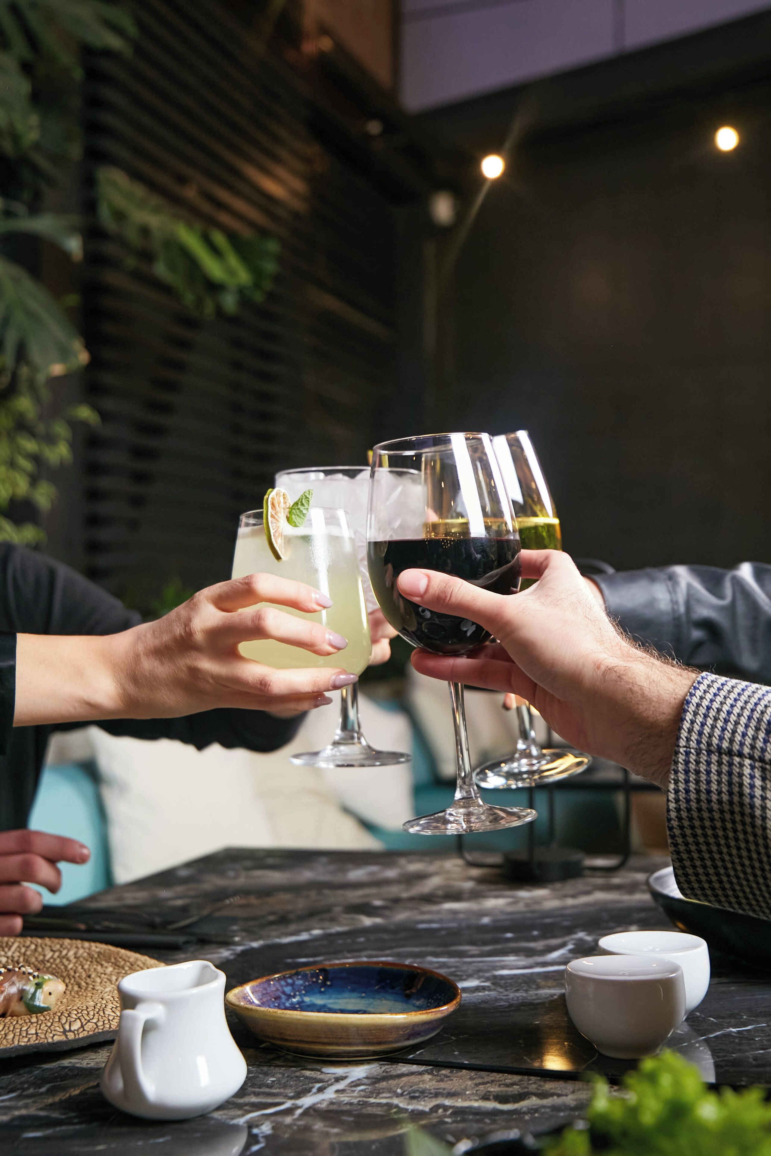 A table with two wine glasses, a pitcher, and a bowl.