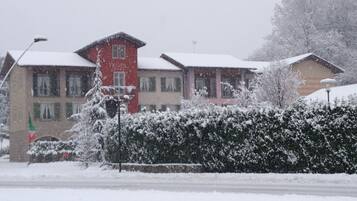 A hotel with a red tower labeled "HOTEL" and multiple windows.