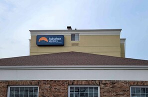 A building with a sign for Suburban Studios, indicating it is part of the Extended Stay by Choice Hotels chain.