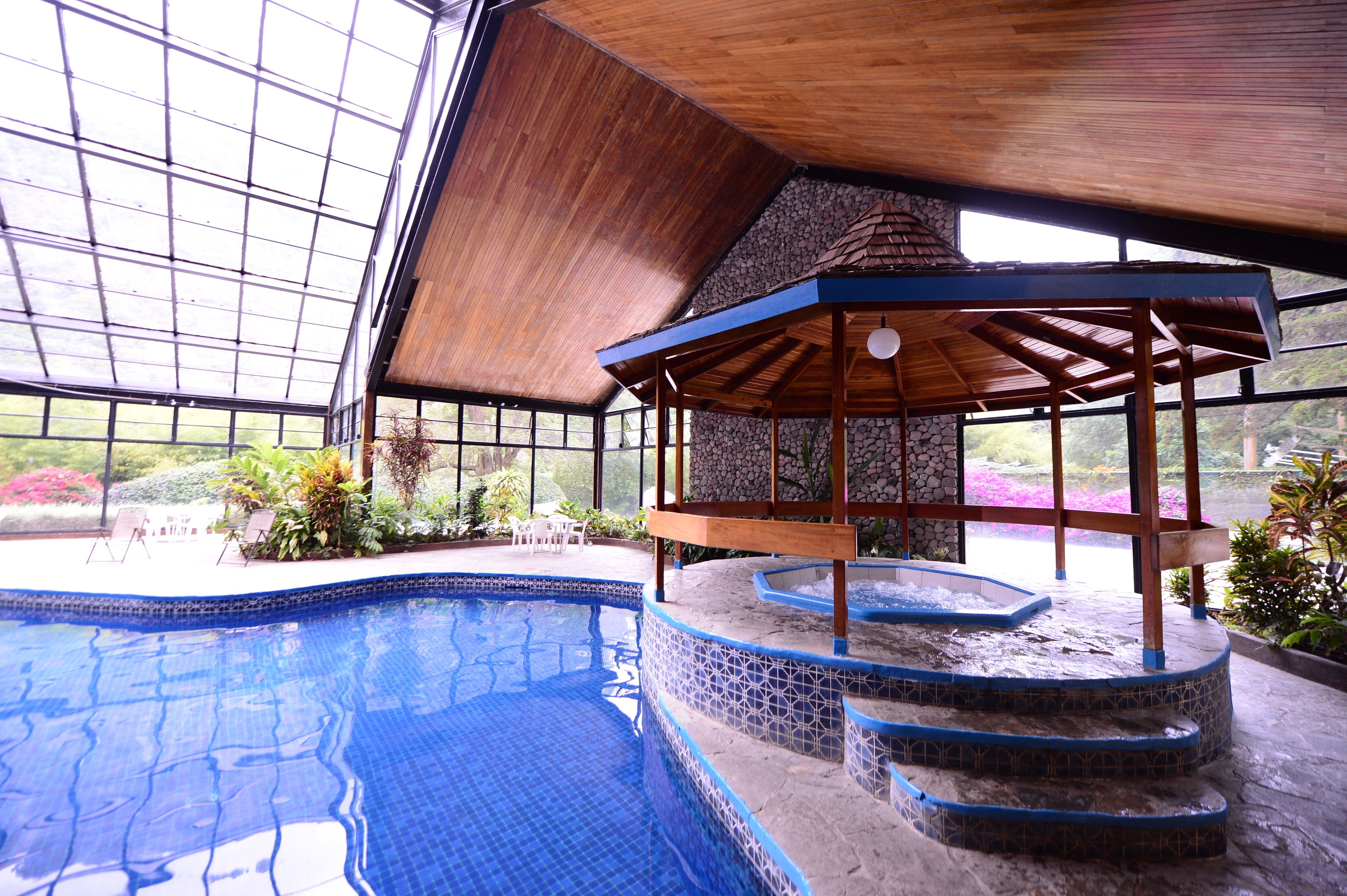Indoor pool, open 8:00 AM to 10:00 PM, pool loungers