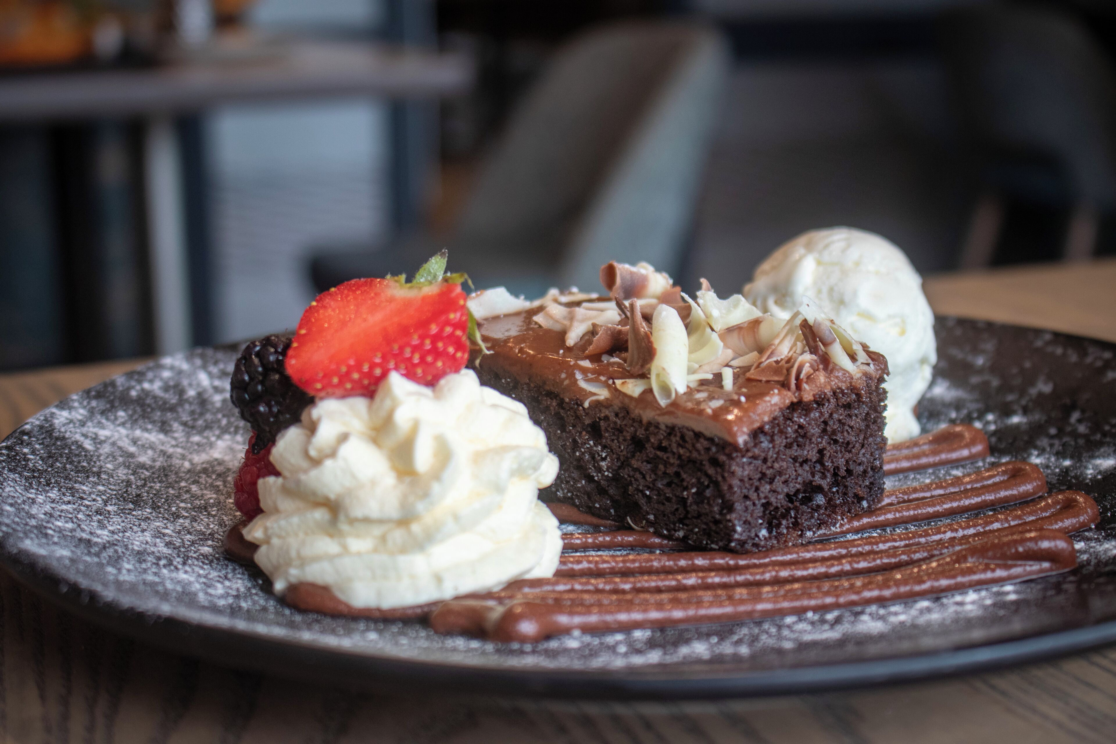A dessert plate with chocolate cake, ice cream, and whipped cream.