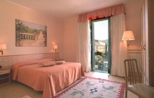 Una scrivania, tende oscuranti, culle/letti per bambini