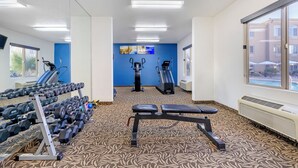 A gym with exercise equipment, a treadmill, and a stationary bike. - Comfort Inn at Convention Center (St. George)