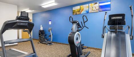 A hotel fitness center with treadmills, an elliptical, and a stationary bike.