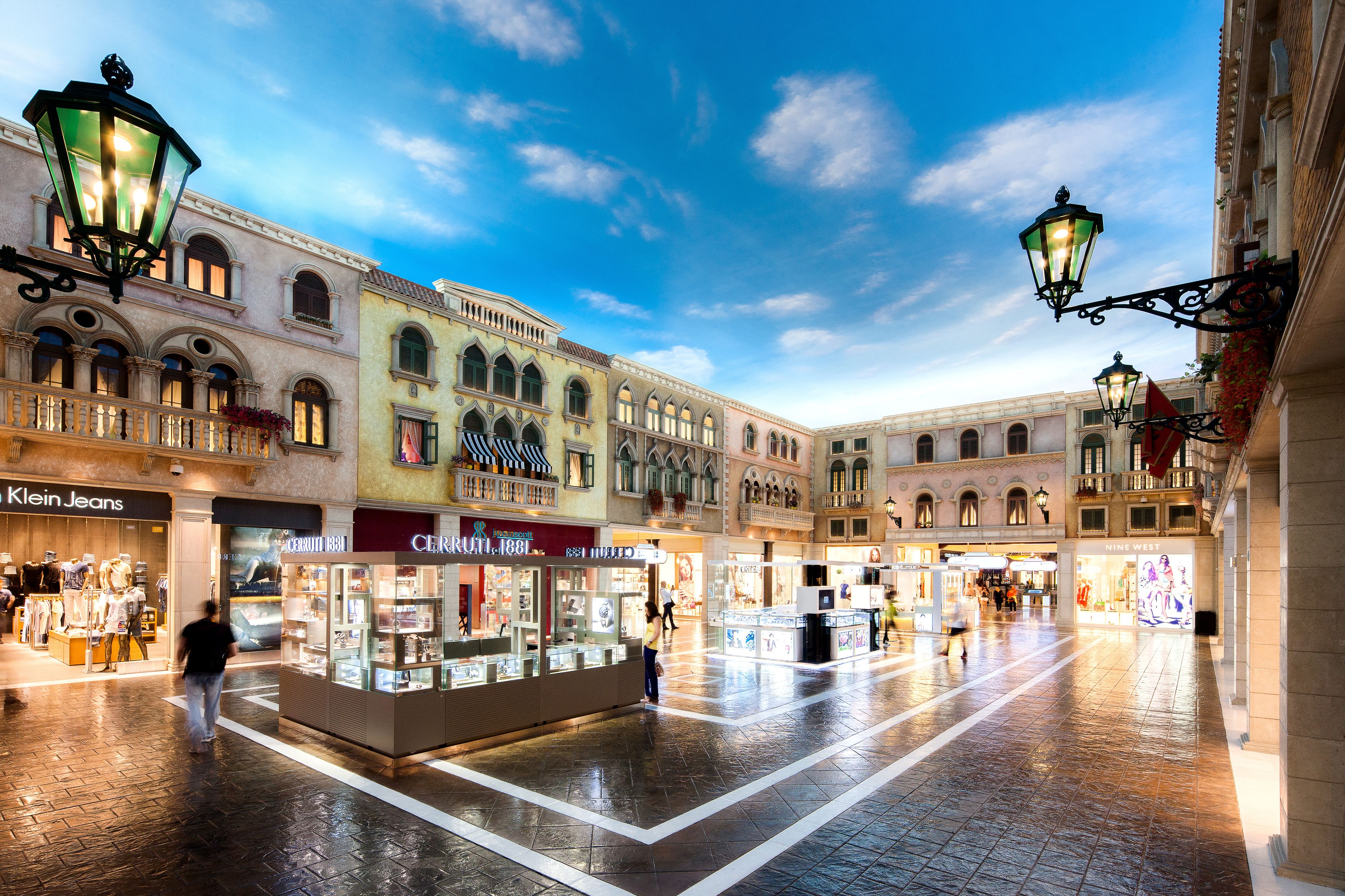 A spacious shopping arcade with multiple storefronts, including a jewelry store and a clothing store.