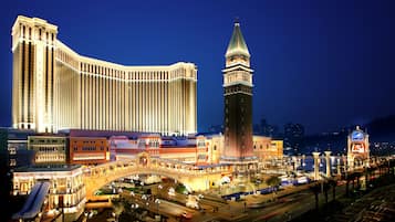 A large hotel with a distinctive tower and a bridge connecting to other buildings.