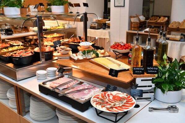 A buffet with various food items and condiments.