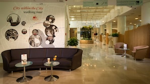 A modern lobby with a map wall, a terrace bar, and a conference center. - City Hotel Ljubljana (Ljubljana)