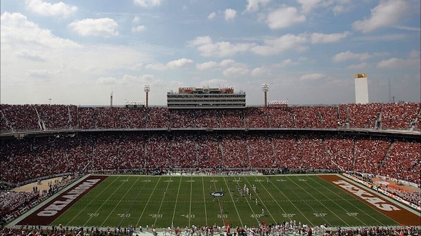 A stadium with a football field, large seating capacity, and a prominent scoreboard. - Motel 6 Dallas, TX – East / Fairpark (Dallas)