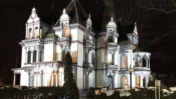 A large, ornate building with multiple towers and domes, illuminated at night. - Batcheller Mansion Inn (Saratoga Springs)