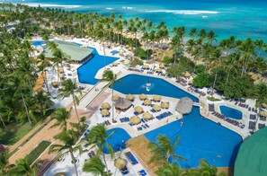An aerial view of a resort with multiple swimming pools, palm trees, and beach areas. - Grand Sirenis Punta Cana Resort & Aquagames - All Inclusive (Punta Cana)