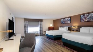A hotel room with two beds, a desk with a chair, a flat-screen TV, and artwork on the walls. - Hilton Garden Inn Hattiesburg (Hattiesburg)