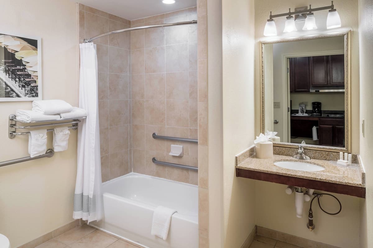 combined shower/bathtub, designer toiletries, hair dryer, towels