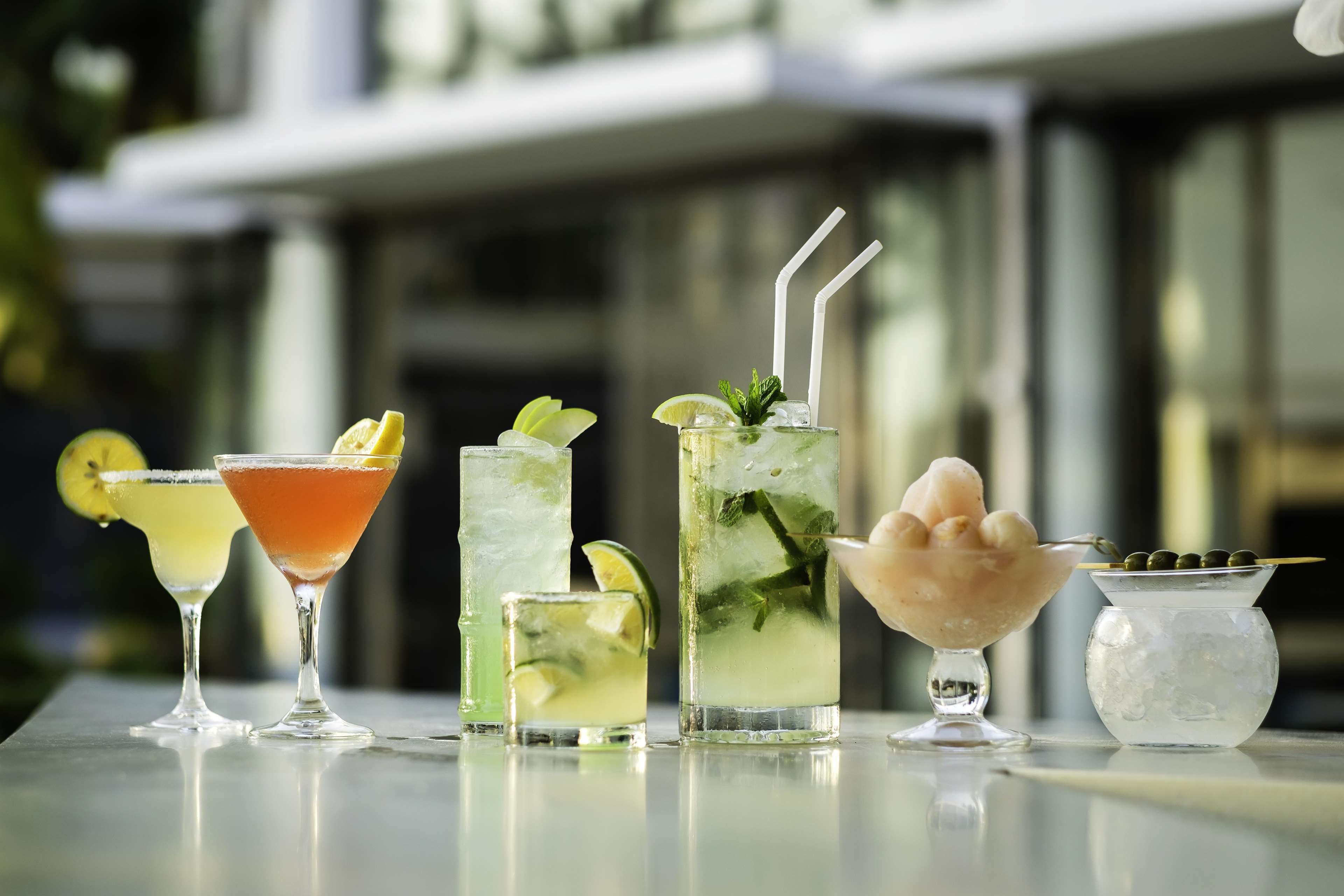 A variety of drinks on a table with a blurred background.