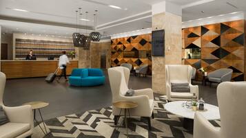 Welcome to our lobby, featuring a reception desk, comfortable seating, and a geometric patterned wall.