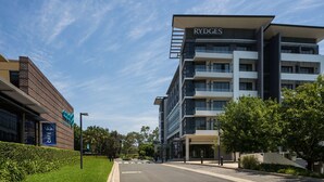 A modern building with a sign reading "RYDGES" and a cafe with a sign reading "CAFE."